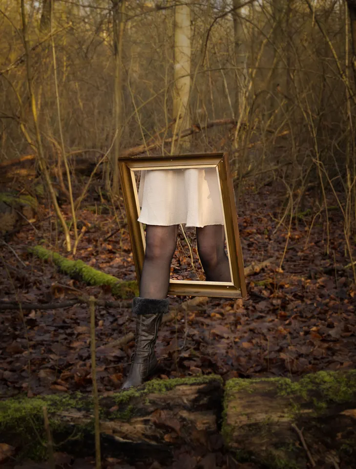 A person appears inside a frame in the woods, photographed by Edith van Aken
